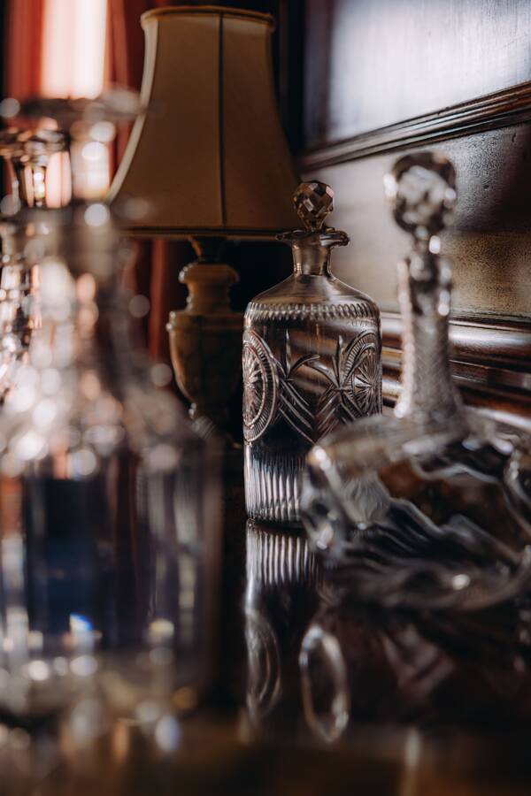 Cut-glass decanters by lamplight at The Salwey Lodge near Ludlow