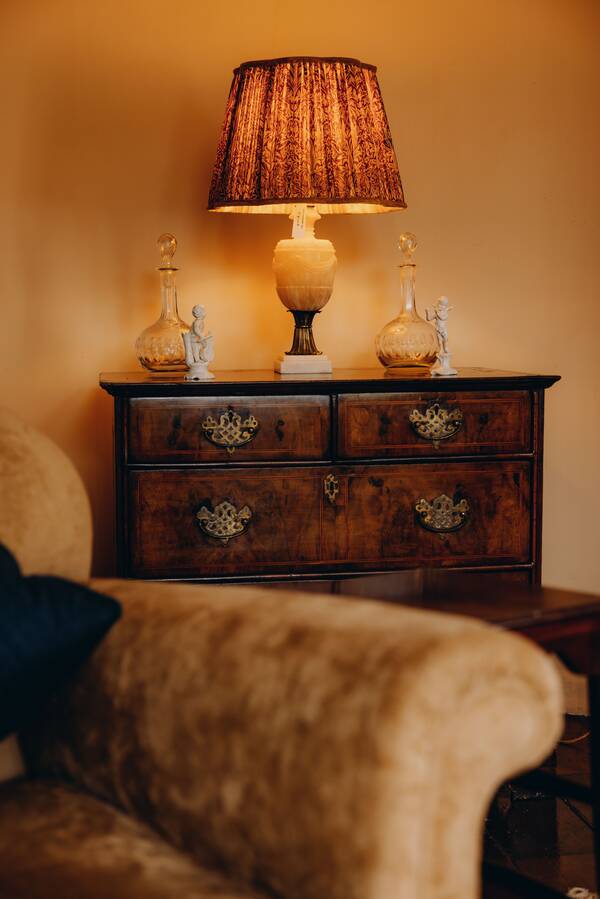 Lamplight on a Georgian chest of drawers at The Salwey Lodge near Ludlow