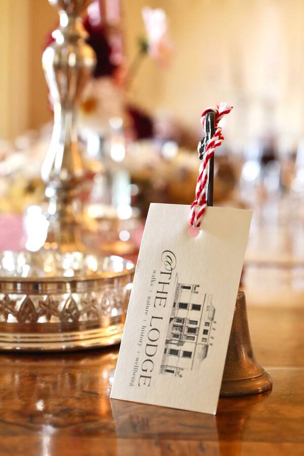 An @The Lodge welcome tag on the dining table at The Salwey Lodge near Ludlow