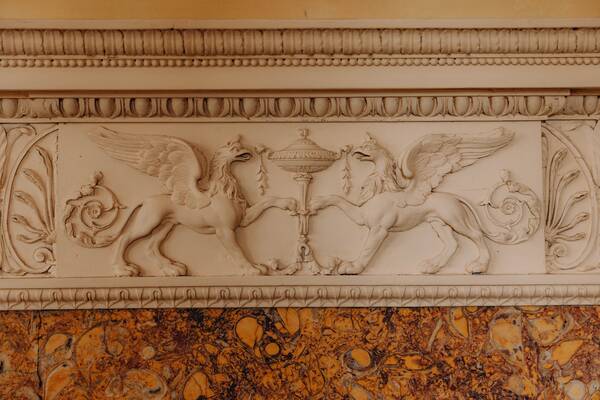Carved griffins on a Georgian mantelpiece at The Salwey Lodge near Ludlow