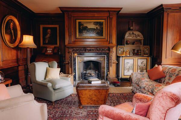 The panelled morning room with open fire at The Salwey Lodge near Ludlow