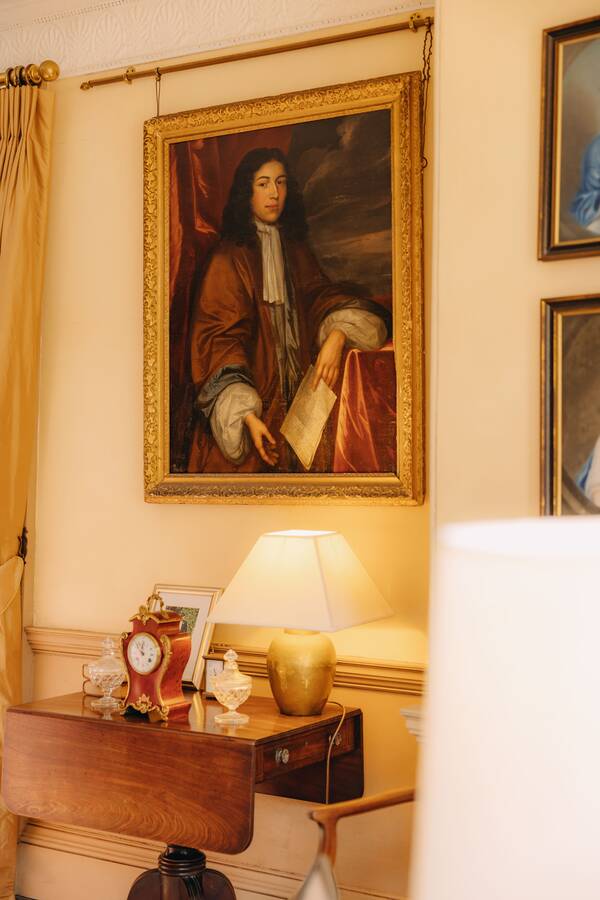 A portrait above a lamp in the hall at The Salwey Lodge near Ludlow