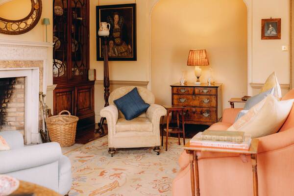 The sitting room with Tudor portrait and armchairs at The Salwey Lodge near Ludlow