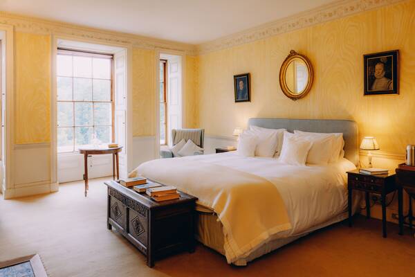 The yellow bedroom with king-size bed, a historic accommodation room at The Salwey Lodge near Ludlow