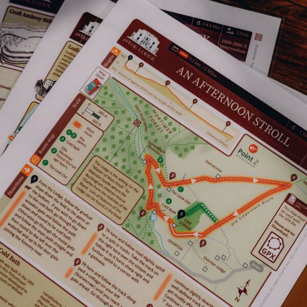 Printed walking route maps from The Salwey Lodge, including An Afternoon Stroll through Mortimer Forest